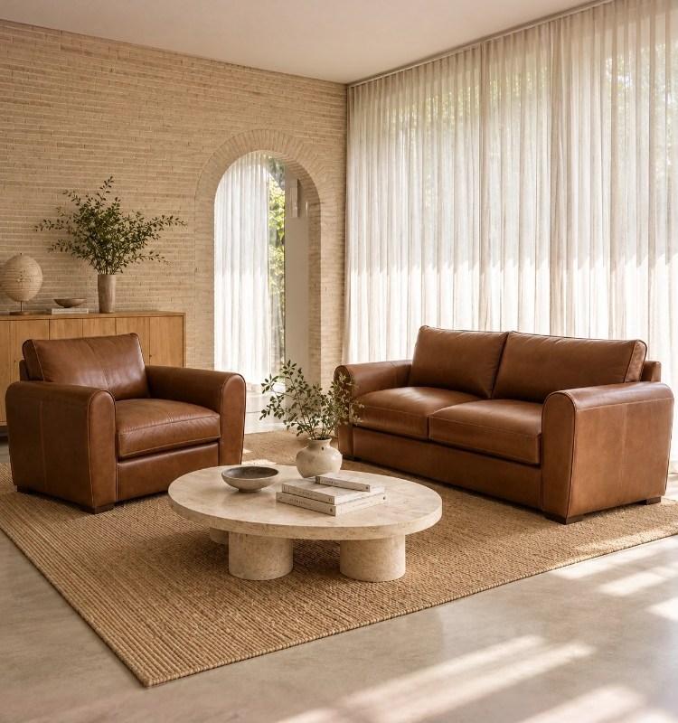 Tan leather Moran sofa and armchair in a sunlit living room